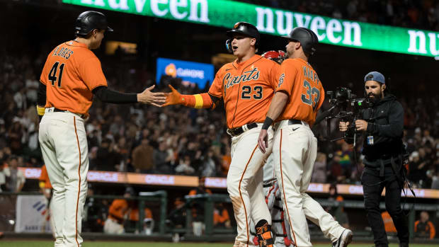 SF Giants outfielder Joc Pederson, infielder Wilmer Flores, and catcher Andrew Knapp celebrate after Pederson's three-run homer.